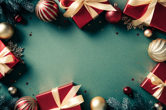 Christmas frame of red gifts and baubles on green background. Vintage retro style, postcard design.