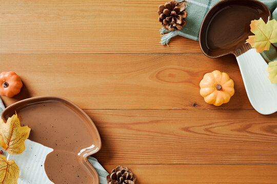Autumn background with mushroom ceramic dishes on wooden background