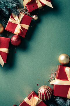 Christmas red gift boxes and baubles frame vertical on green background. Xmas vertical banner template. Vintage, retro style
