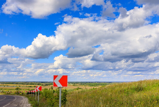 Clear sky with puffy clouds over open field