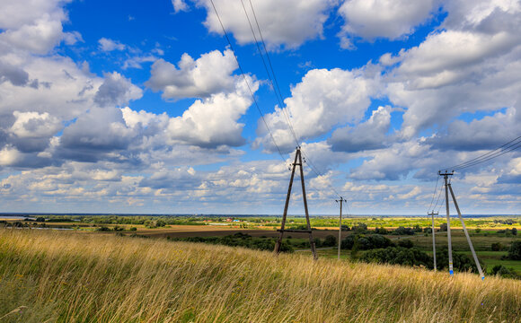 Open grassy plain under vast sky with scattered clouds