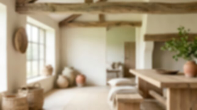 Rustic farmhouse dining room interior featuring exposed wooden ceiling beams and natural clay pottery. Soft focus view of a wooden table and wicker baskets in a bright home setting.