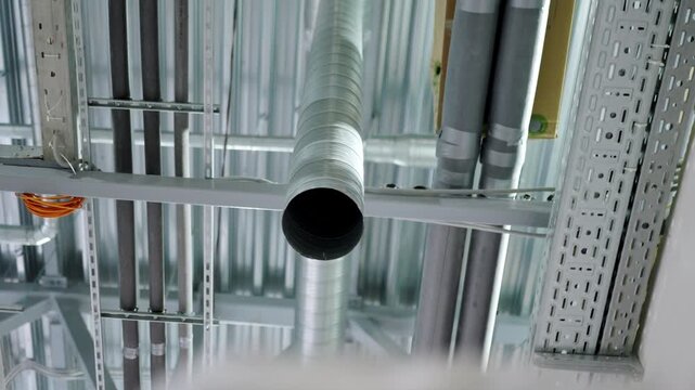 Ceiling displays routed pipes and electrical cable tray systems. Industrial engineering design delivers efficient utility infrastructure