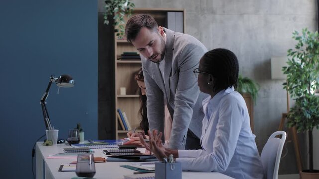 Male supervisor mentoring african american female employee