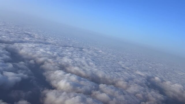 An immersive pilot&rsquo;s perspective from a jet cockpit while flying at supersonic speed over a an endless layer of stratus clouds at sunset.4K shot.