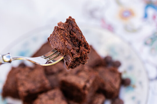 stack of chocolate gluten free brownie slices on plate at party