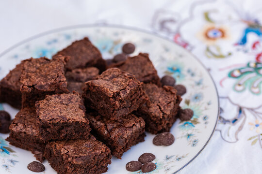 stack of chocolate gluten free brownie slices on plate at party