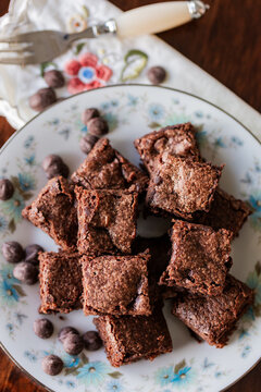 stack of chocolate gluten free brownie slices on plate at party