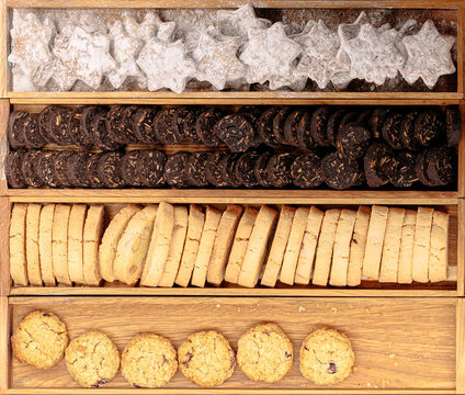 Assortment of delicious cookies arranged in wooden trays for a festive treat