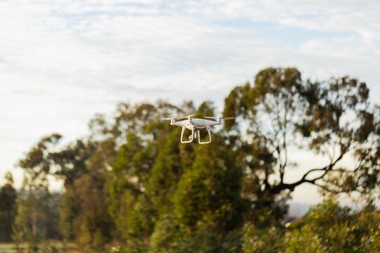 RPA drone hovering in sky above rural paddock
