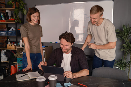 Group of colleagues brainstorming together in a casual modern office setting