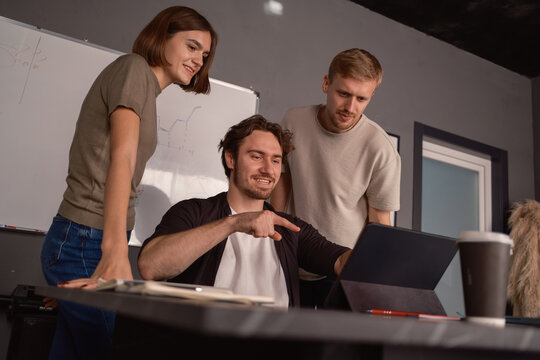 Team collaborating and discussing ideas while working together on a project in office