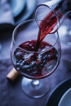 Red wine pouring into a glass