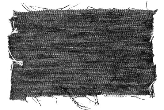 Piece of black torn denim on a white background. Denim texture