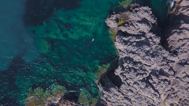High Aerial View of Freediver Beside Limestone Coast at Voidokilia, Greece