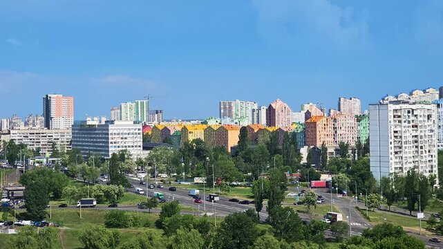 Panoramic view of a modern urban cityscape with colorful apartment buildings and busy traffic on a sunny day