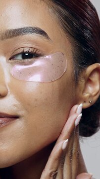 Happy, face and woman with eye mask in studio for anti aging, dark circles and skin hydration. Portrait, skincare and person with patches for beauty, self care and facial wellness on white background