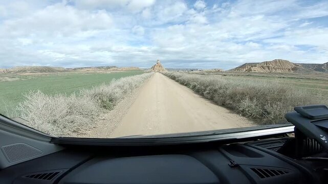 On the road toward Castildetierra, filmed through windshield, semi-desert Bardenas Reales, Spain