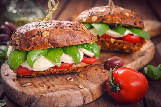 Italian Caprese sandwiches with fresh tomatoes, mozzarella cheese and basil
