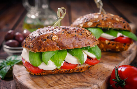 Italian Caprese sandwiches with fresh tomatoes, mozzarella cheese and basil