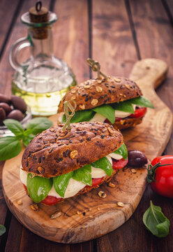 Italian Caprese sandwiches with fresh tomatoes, mozzarella cheese and basil