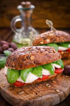 Italian Caprese sandwiches with fresh tomatoes, mozzarella cheese and basil