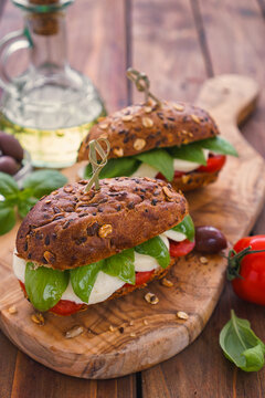Italian Caprese sandwiches with fresh tomatoes, mozzarella cheese and basil
