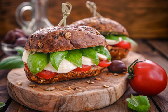 Italian Caprese sandwiches with fresh tomatoes, mozzarella cheese and basil