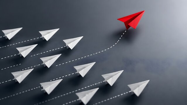 Red paper airplane changing direction and breaking away from a group of white airplanes representing business innovation leadership and unique corporate strategy.