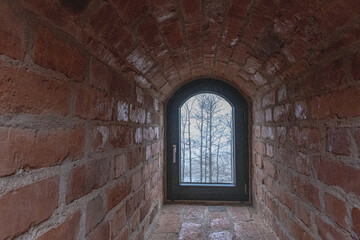 Naklejka premium Visiting the historic Trakai Castle on a cold, cloudy, foggy, and wet winter day, Trakai, Lithuania 