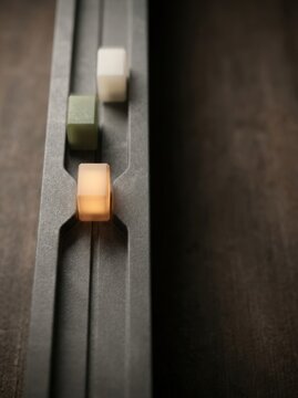 Workflow bottleneck alert with one glowing amber task block paused among three process signals in a narrow channel, minimal vertical business report cover with dark copy space