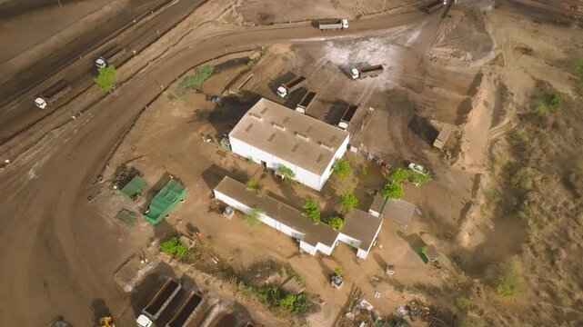Thar Engro Coal Mining support buildings sit amid trucks and dirt roads in a dry Sindh landscape, viewed from a high drone angle.