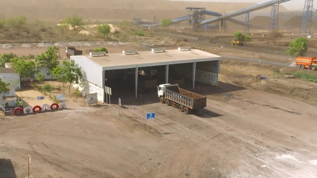 High angle perspective showing a dumper truck reversing inside a warehouse at the THAR Engro Coal Mining site in Sindh, Pakistan