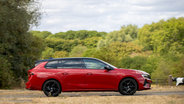 Milton Keynes; UK - Aug 22nd 2026:; 2025 red Vauxhall Astra gs turbo estate car driving on a British road
