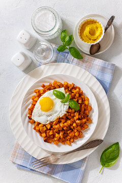 Crispy potato cubes cooked with diced sausage