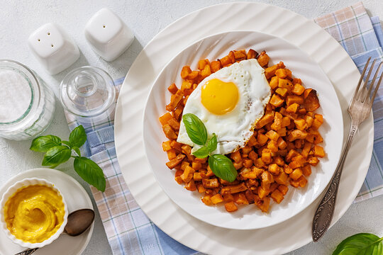 Crispy potato cubes cooked with diced sausage