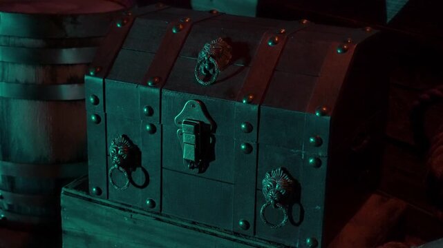 Pirate chest sits on wooden deck. Medium shot.