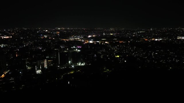 Night dark sky with illuminated city and Hussain Sagar Lake at hyderabad, telangana, india. night time, push in shot, drone shot, 4k.