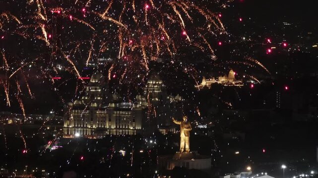 Colourful Fireworks explosive blast on sky with background 125feets Dr. B. R. Ambedkar's Statue, secretariat and Birla Temple at hyderabad, telangana, india. night time, crane shot, drone shot, 4k.