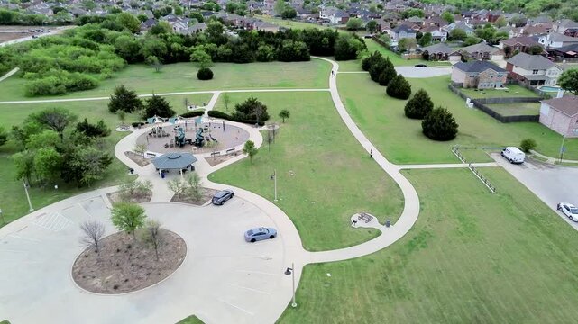 Central play structures sit within Eden Road Park bordering Mansfield Webb Road neighborhood. Circular parking turnaround, shade pavilion, green expanses serve local residents, Arlington, Texas