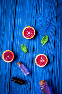 organic cosmetic with citrus on blue background top view