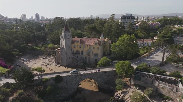 Aerial - Museu Condes De Castro Guimaraes Beside Its Stone Bridge And Small Beach In Cascais Portugal