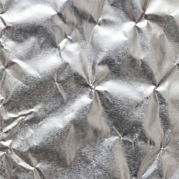 Crinkled aluminum foil texture with a metallic sheen and repeating diamond pattern