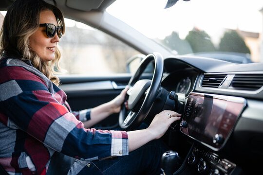 Young woman driving car on road trip