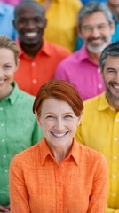 Obraz premium A smiling woman with red hair in an orange shirt stands in the foreground with a diverse group of colorful people in the.