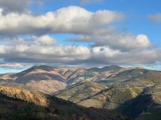 Fototapeta premium Mountain range of Arouca geopark under cloudy blue sky, Canelas, Aveiro, Portugal, July 2025
