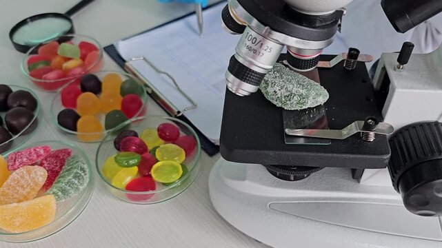 Using a microscope to examine different types of candy and their textures at a lab setting