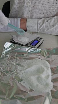 Scene showing money and a scale with a white substance