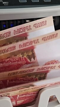 Money counts on a machine in a bank at midday