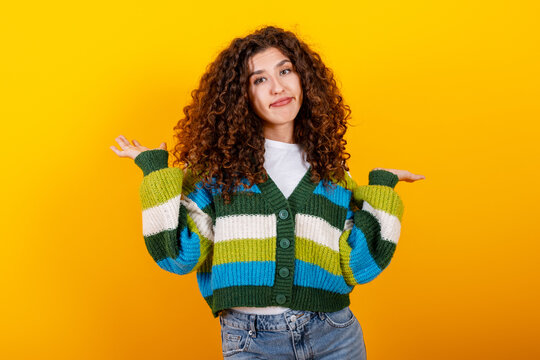 Woman shrugging feeling confused and uncertain